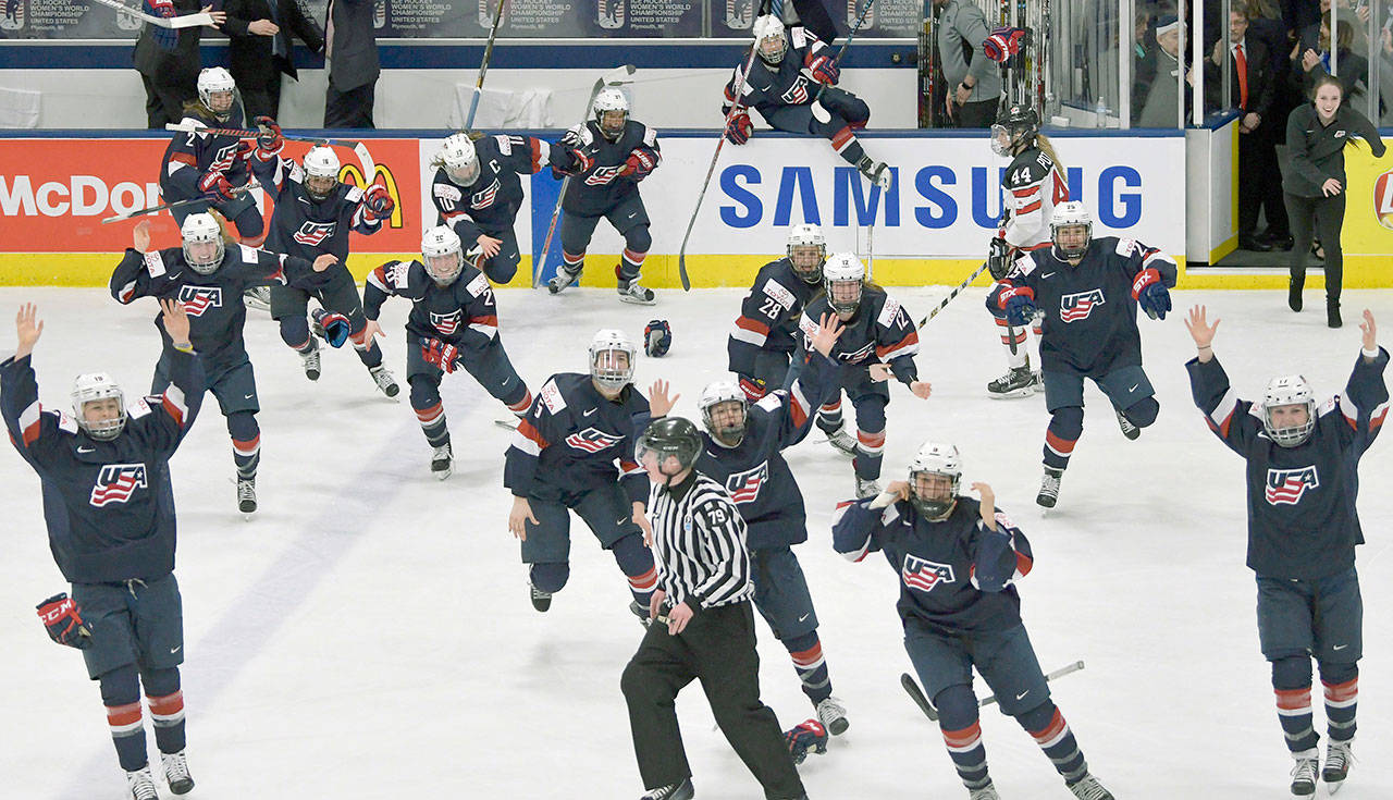 U.S. players celebrate after a 3-2 overtime win over Canada during the gold medal game of the women’s hockey world championships on Friday in Plymouth, Michigan. (Jason Kryk/The Canadian Press via AP)