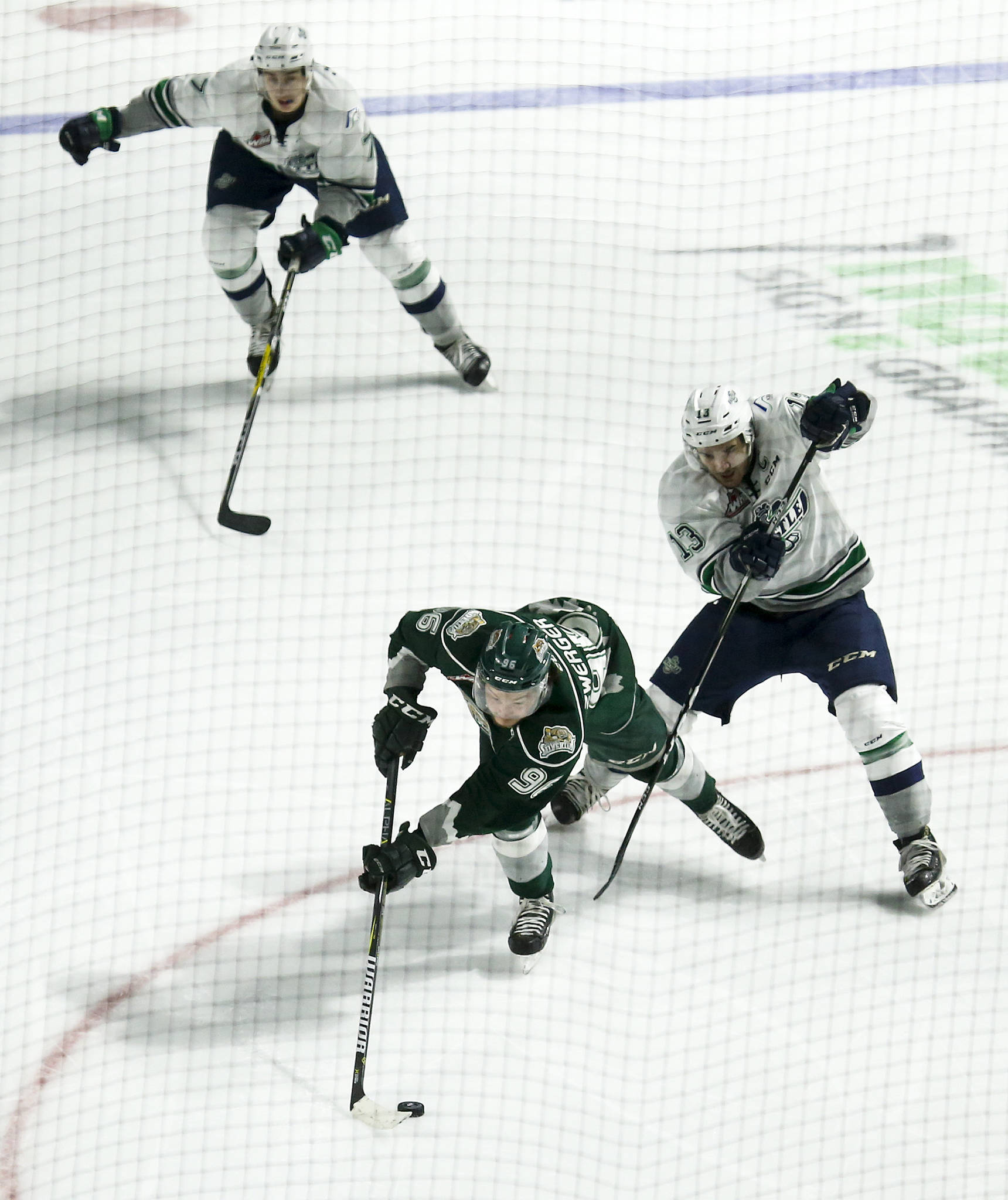 Silvertips left wing Dominic Zwerger (bottom) skates past the Thunderbirds’ Mathew Barzal (right) and Reece Harsch (top) during Game 3 of a second-round playoff series on April 11, 2017, at the ShoWare Center in Kent. (Ian Terry / The Herald)