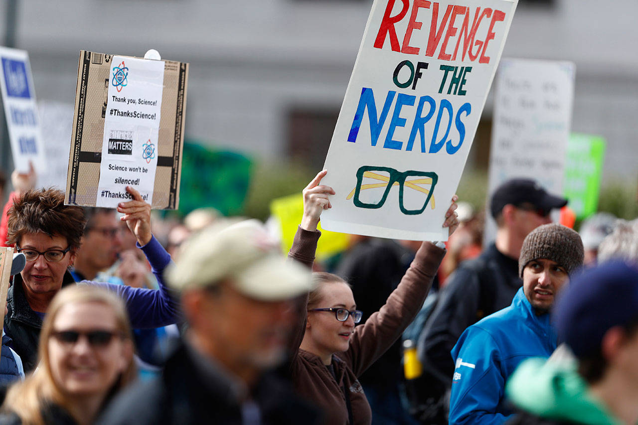 Protesters carry signs during a March for Science on Saturday in Denver. (David Zalubowski Associated Press)