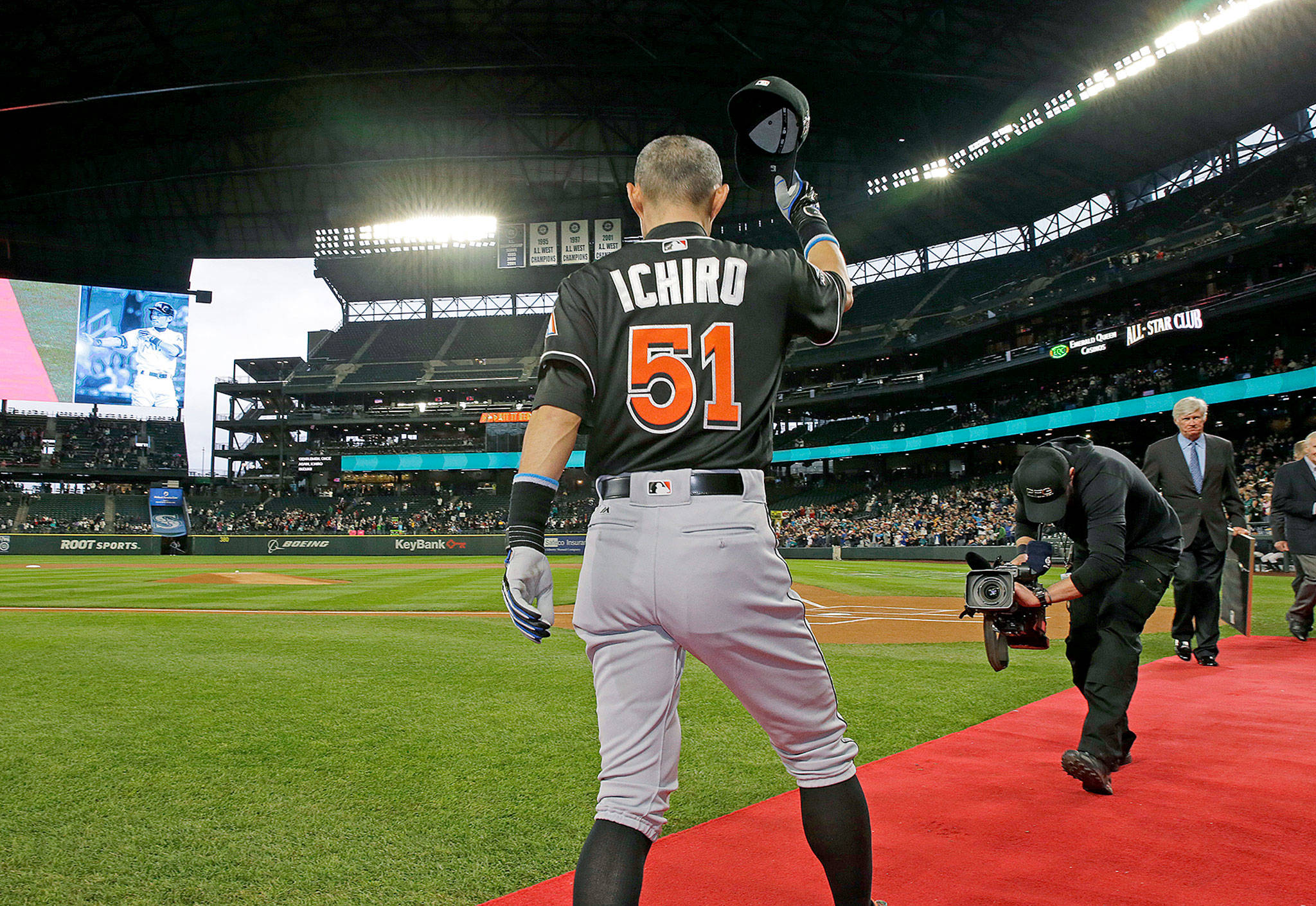 Miami Marlins’ Ichiro Suzuki tips his cap after being honored by Seattle Mariners players and executives for his 3,000 hit milestone in a pre-game ceremony before a baseball game against the Mariners, his former team, on Monday in Seattle. (AP Photo/Ted S. Warren)