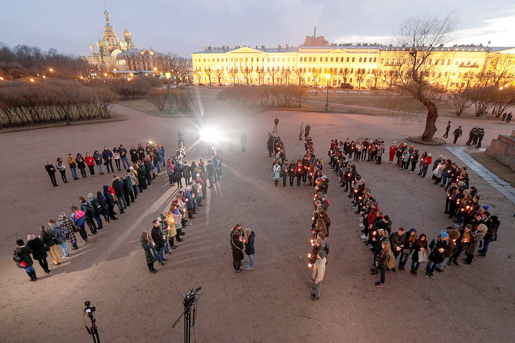 People form digits of the time of the subway bombing in memory of victims of the tragic event in St.Petersburg, Russia, on Wednesday. (AP Photo/Dmitri Lovetsky)