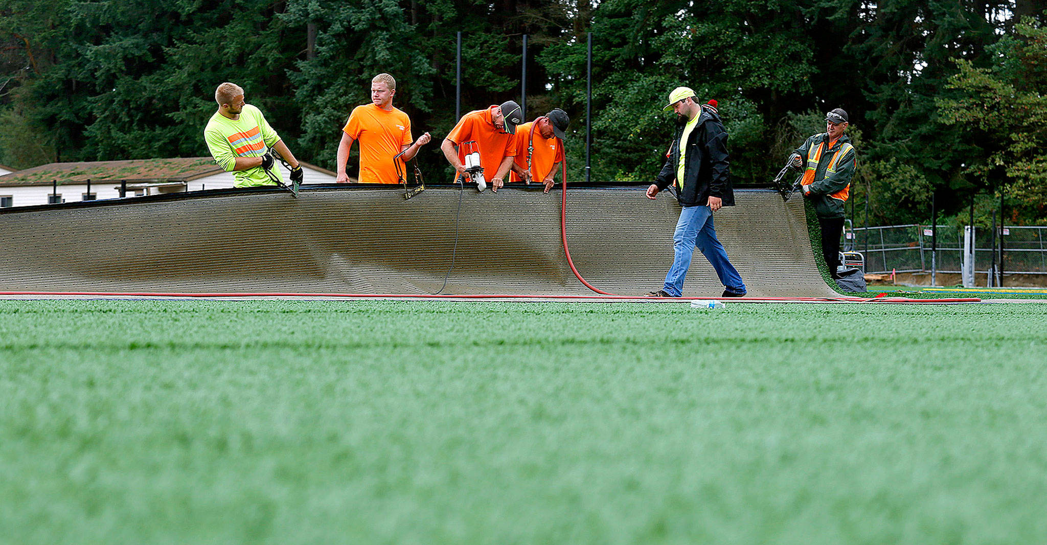 Contractors install artificial turf on the fields at the old Woodway High School in 2015. (Herald file)