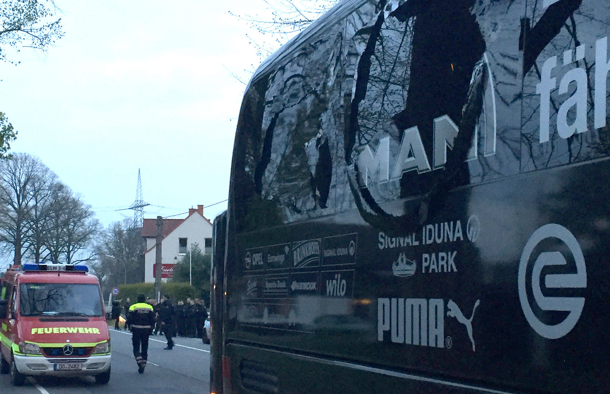 A window of the bus of the Borussia Dortmund soccer team is damaged after an explosion Tuesday before the Champions League quarterfinal against AS Monaco in Dortmund, Germany. The game was postponed until Wednesday. (Carsten Linhoff/dpa via AP)