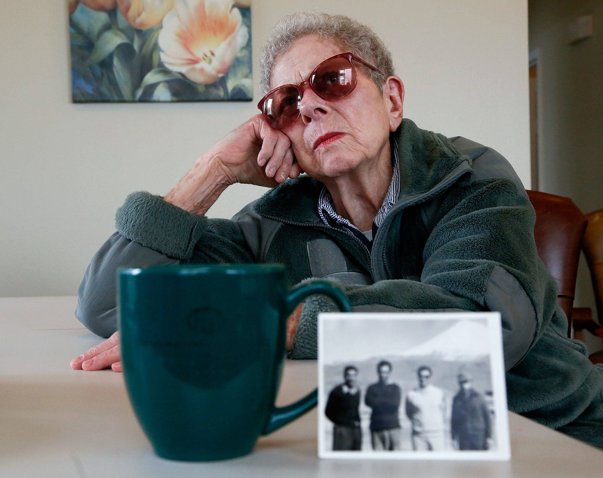 Everett’s Doris Sinclair, 88, reflects on a chilling experience she had while traveling by train from Iran to Soviet Georgia in 1964. Detained by Soviet authorities, she was interrogated for three days before being allowed to continue with her trip. Sinclair and her husband, who was in the U.S. Air Force, lived in Iran from 1963 to 1968. In the foreground is a photo of several men in Iran, one of whom was her driver in those years. (Dan Bates / The Herald)