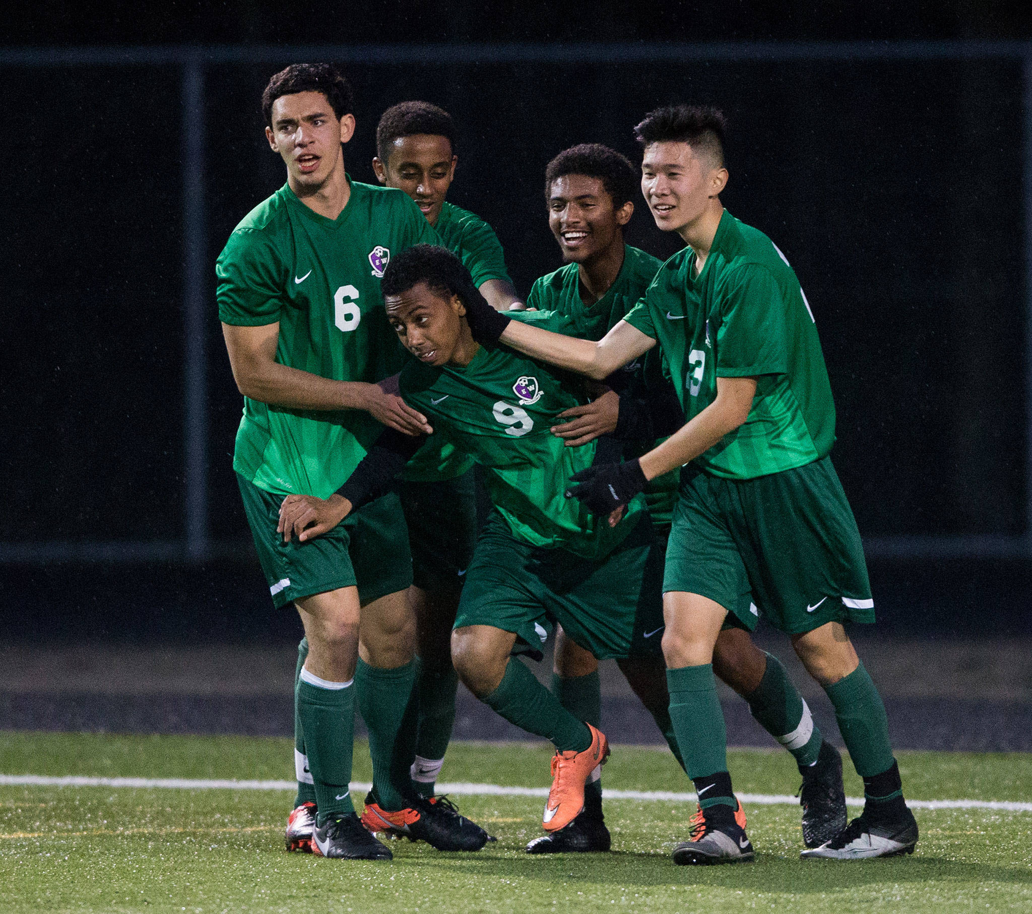 Edmonds-Woodway’s Simon Ghebreamiak, (9) is congratulated by teammates after scoring a goal during a game against Lynnwood on April 5, 2017, in Bothell. (Andy Bronson / The Herald)