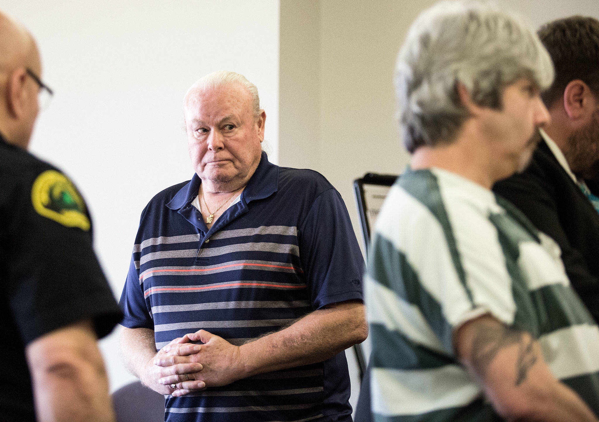 Patrick Shunn, the namesake uncle of murder victim Patrick Shunn, looks at Tony Reed (right) after asking the court to hand down a long sentence for Reed at the Snohomish County Courthouse on Monday in Everett. Reed was sentenced to 14 months in jail with time served for helping his brother dispose of the bodies of Shunn and Monique Patenaude of Oso. (Andy Bronson / The Herald)