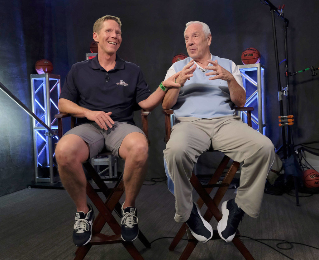 Gonzaga men’s basketball coach Mark Few (left) shares a laugh with North Carolina coach Roy Williams during in interview with CBS on Sunday in Glendale, Arizona. (AP Photo/David J. Phillip)
