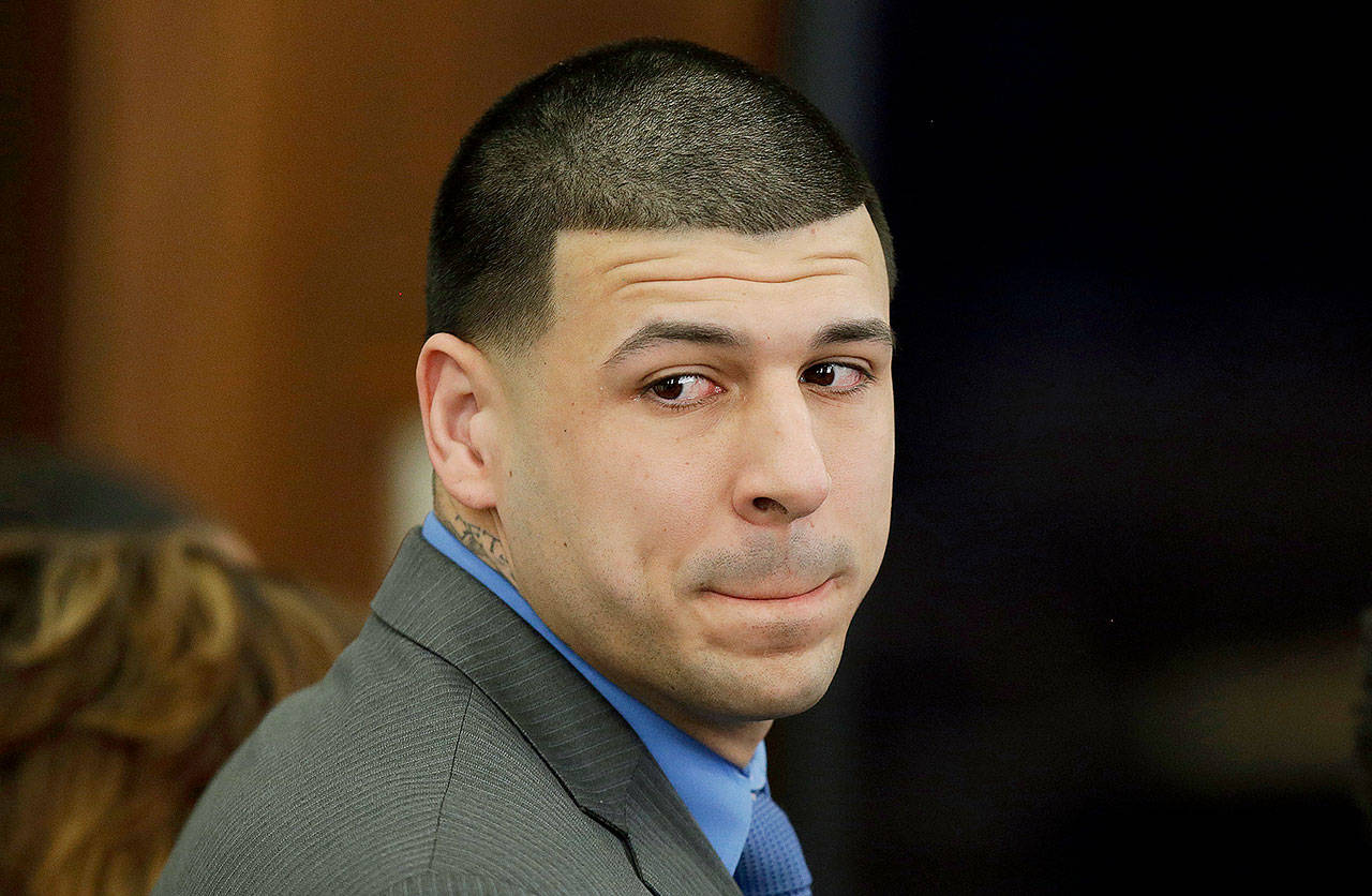 Former New England Patriots tight end Aaron Hernandez turns to look in the direction of the jury as he reacts to his double-murder acquittal in Boston on Friday. Hernandez hung himself in prison early Wednesday, according to officials. (AP Photo/Stephan Savoia, Pool, File)