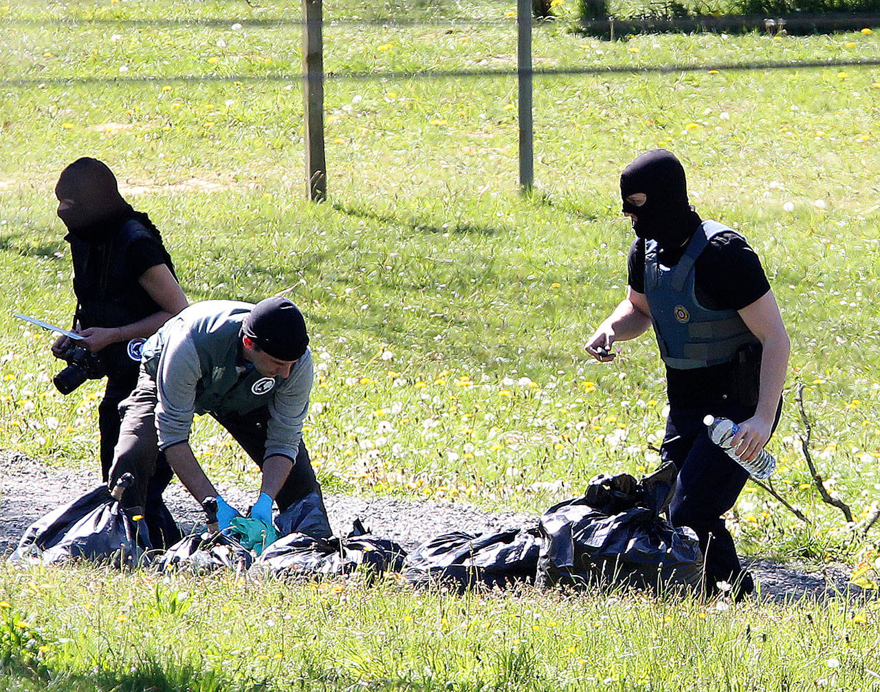 French police officers collect bags at a hideout used by Basque separatist guerrillas in Saint Pee sur Nivelle, France, on Saturday. (AP Photo/Bob Edme)
