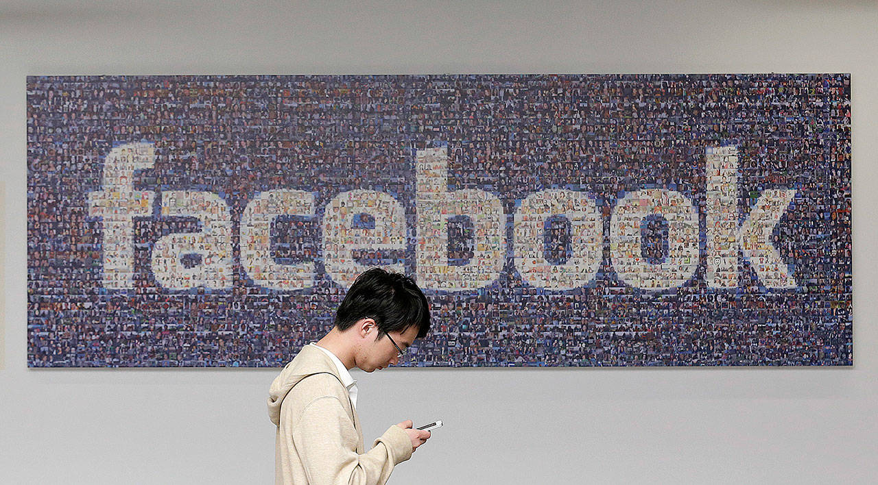 A man walks at the Facebook campus in Menlo Park, California, in 2014. (AP Photo/Jeff Chiu)