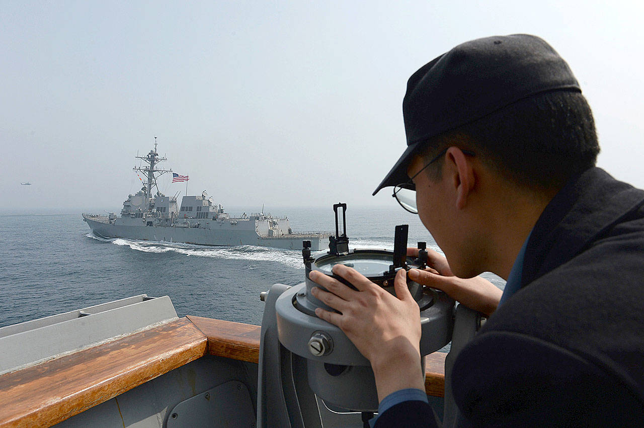 A South Korean sailor watches the destroyer USS Wayne E. Meyer during a joint exercises between the U.S. and South Korea in South Korea’s West Sea on Tuesday. (South Korean Defense Ministry)