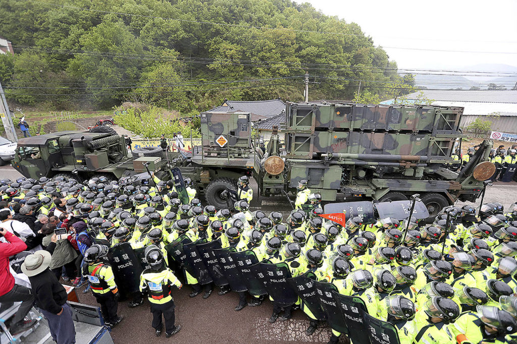 U.S. military vehicle moves as South Korean police officers try to block residents and protesters who oppose a plan to deploy an advanced U.S. missile defense system called Terminal High-Altitude Area Defense, or THAAD, in Seongju, South Korea on Wednesday, April 26. (Kim Jun-hum/Yonhap via AP)
