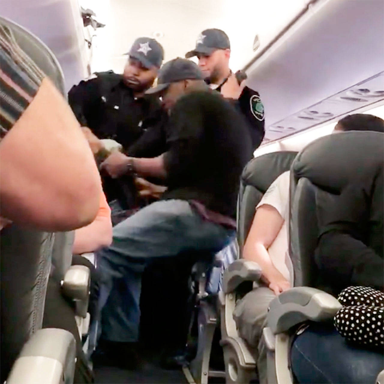 Police remove a passenger from a United Airlines flight in Chicago on April 9. (Audra D. Bridges via Facebook)