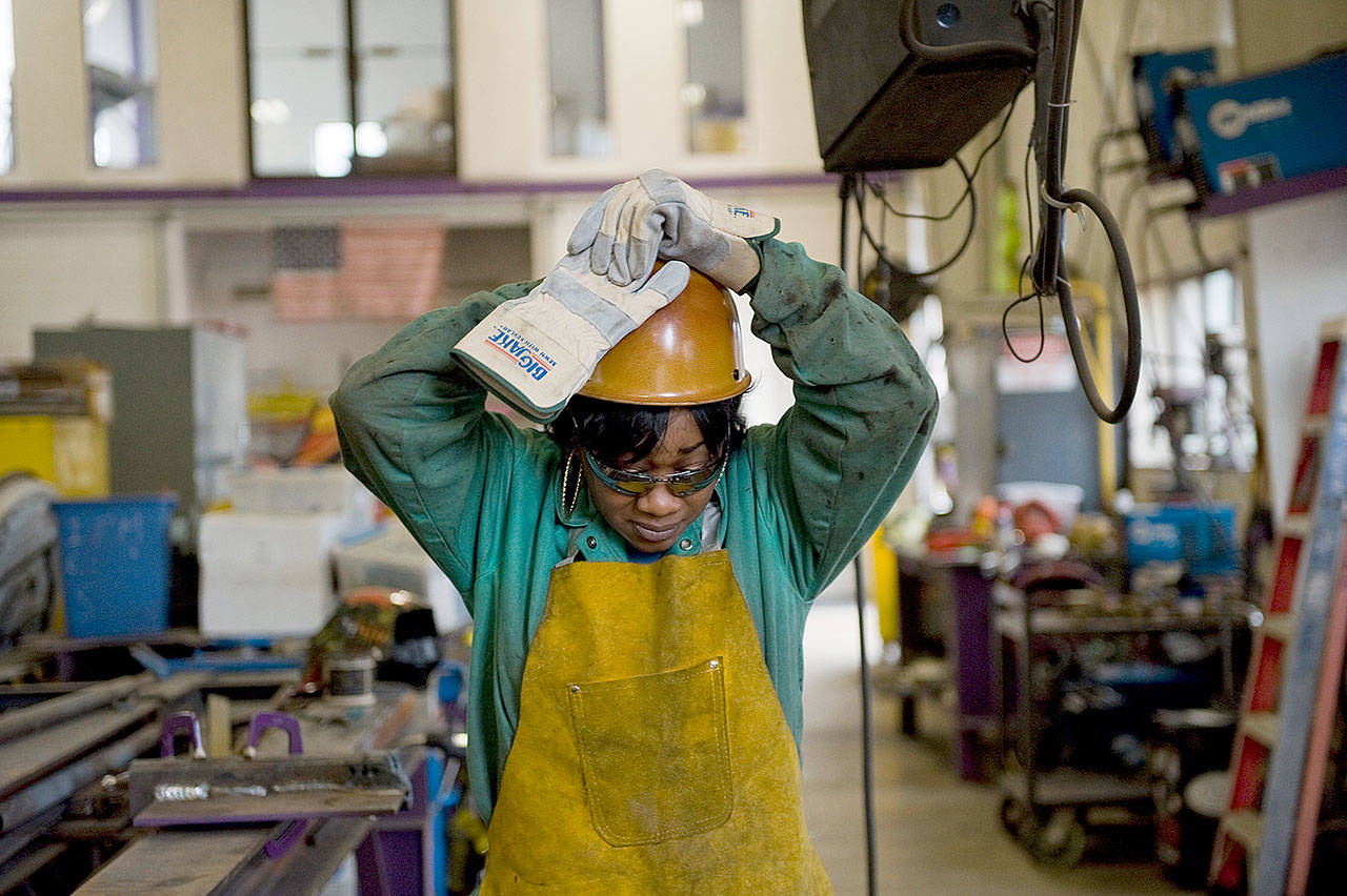 Journeywoman ironworker Bridget Booker dons her hard hat on a job site in East Peoria, Illinois, on Wednesday. (David Zalaznik / For The Washington Post)