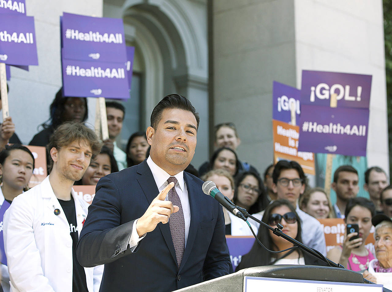 In this 2016 photo, California state Sen. Ricardo Lara, D-Bell Gardens, speaks at a rally at the Capitol in Sacramento, California. California lawmakers are considering an audacious proposal that would substantially remake the state’s health care system by eliminating insurance companies and guaranteeing coverage for everyone. Lara, who wrote the bill with Democratic Sen. Toni Atkins of San Diego, says they’re working on details. (AP Photo/Rich Pedroncelli, File)