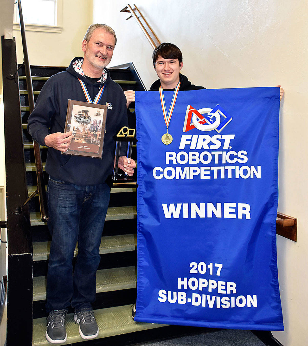 Arlington High School NeoBots mentor Mark Ehrhardt and treasurer Burch Walker show the awards the team earned during the FIRST Robotics Competition April 19-22 in Houston, Texas. (Contributed photo)