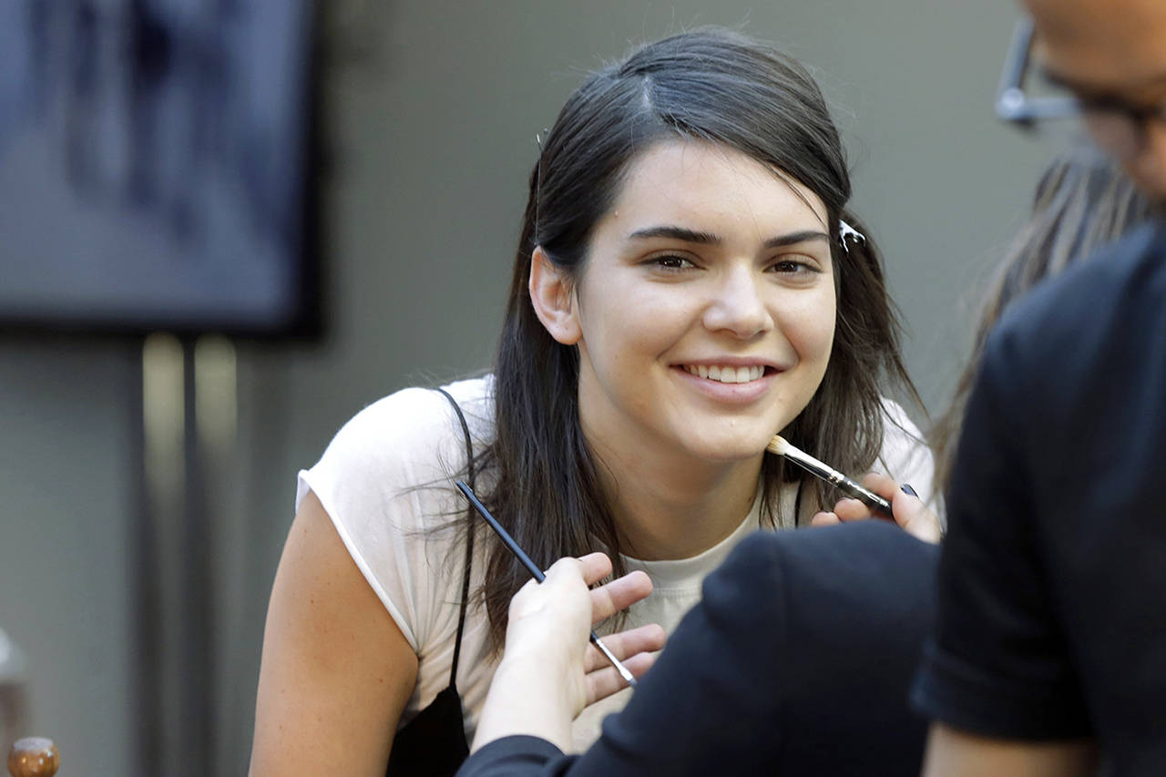 In this 2016 photo, model Kendall Jenner has makeup applied backstage before the Michael Kors Spring 2017 collection is modeled during Fashion Week, in New York. (AP Photo/Richard Drew, File)