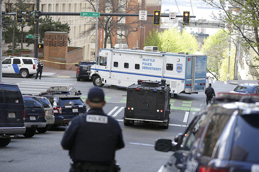 A Seattle Police vehicle turns near the scene of a shooting involving several police officers in downtown Seattle on Thursday, April 20. (AP Photo/Ted S. Warren)
