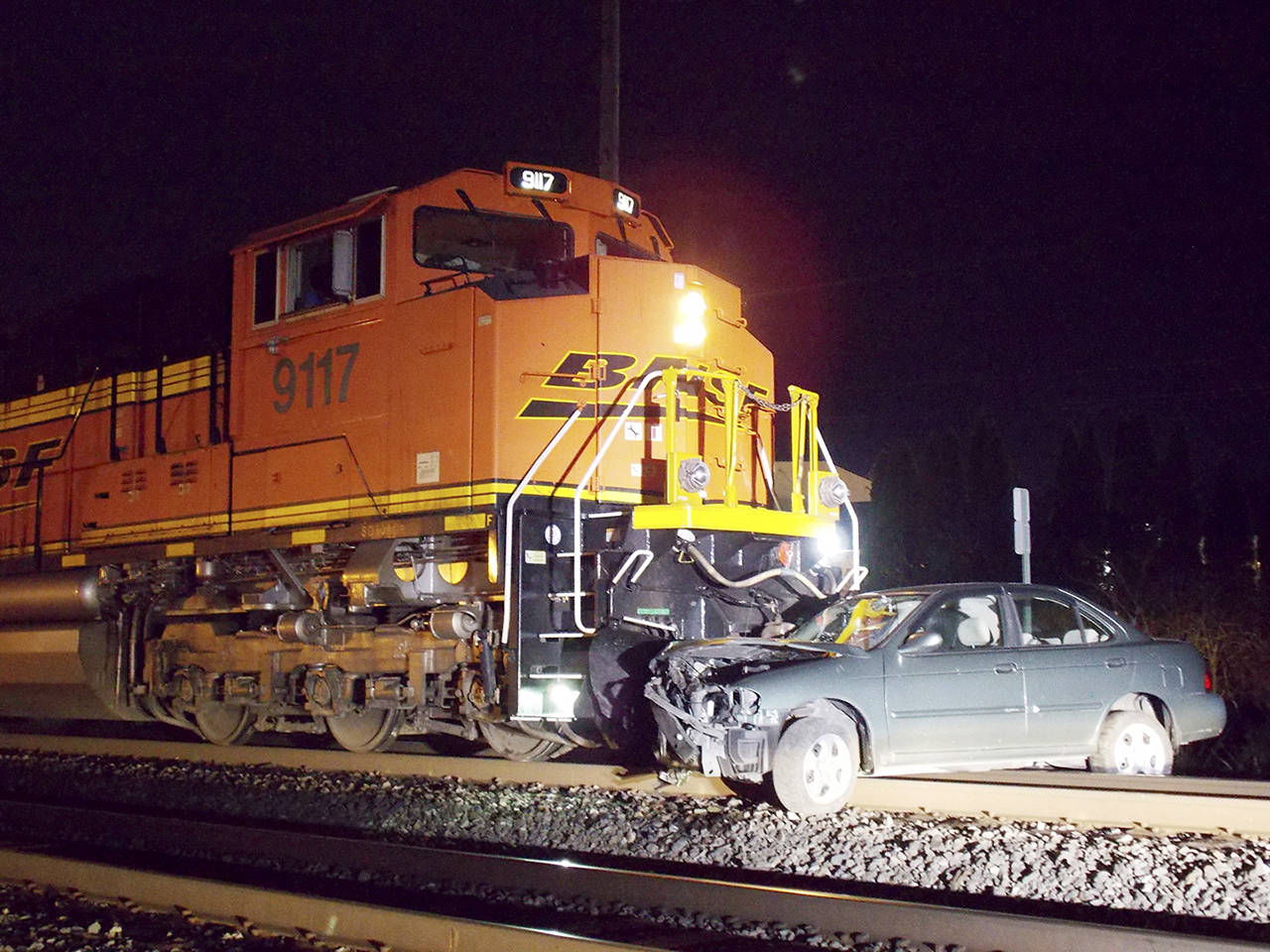 An abandoned car was hit by a train in Monroe late Friday. (Monroe Police)