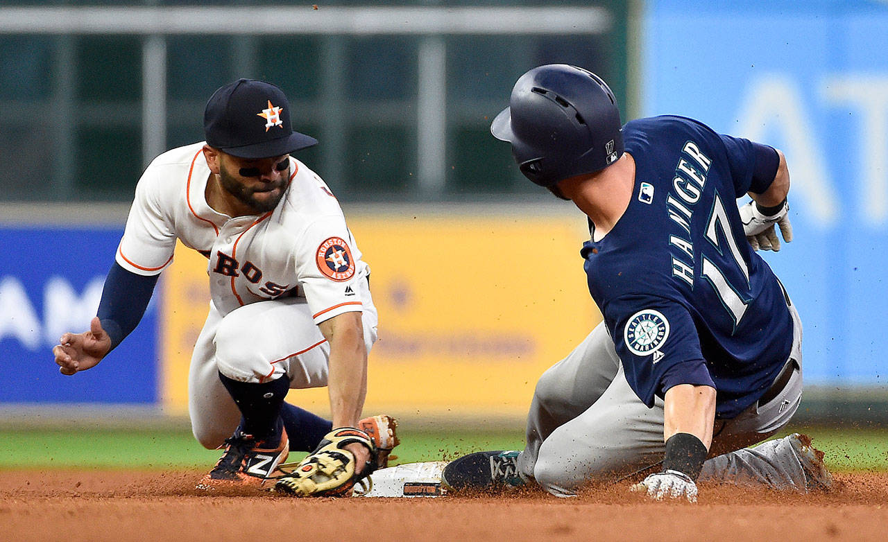 The Mariners’ Mitch Haniger (17) slides safely into second for a double in front of Astros second baseman Jose Altuve during the fourth inning of a game April 4, 2017, in Houston. (AP Photo/Eric Christian Smith)