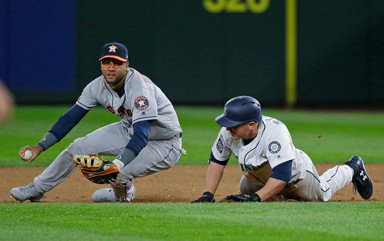 Astros first baseman Yuli Gurriel (left) looks to the infield after tagging out the Mariners’ Kyle Seager in a rundown between first and second bases during the sixth inning of a game April 11, 2017, in Seattle. (AP Photo/Ted S. Warren)