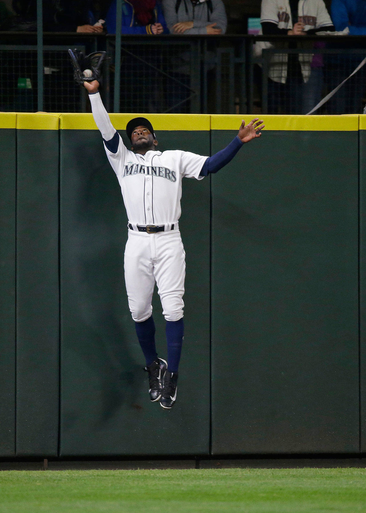 Mariners left fielder Guillermo Heredia leaps to rob the Marlins’ Marcell Ozuna of a home run during the first inning of a game April 18, 2017, in Seattle. (AP Photo/Ted S. Warren)