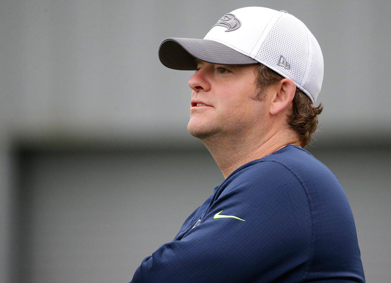 Seattle Seahawks general manager John Schneider watches his team work out during training camp on Aug. 6, 2016, in Renton. (Ted S. Warren / Associated Press, file)