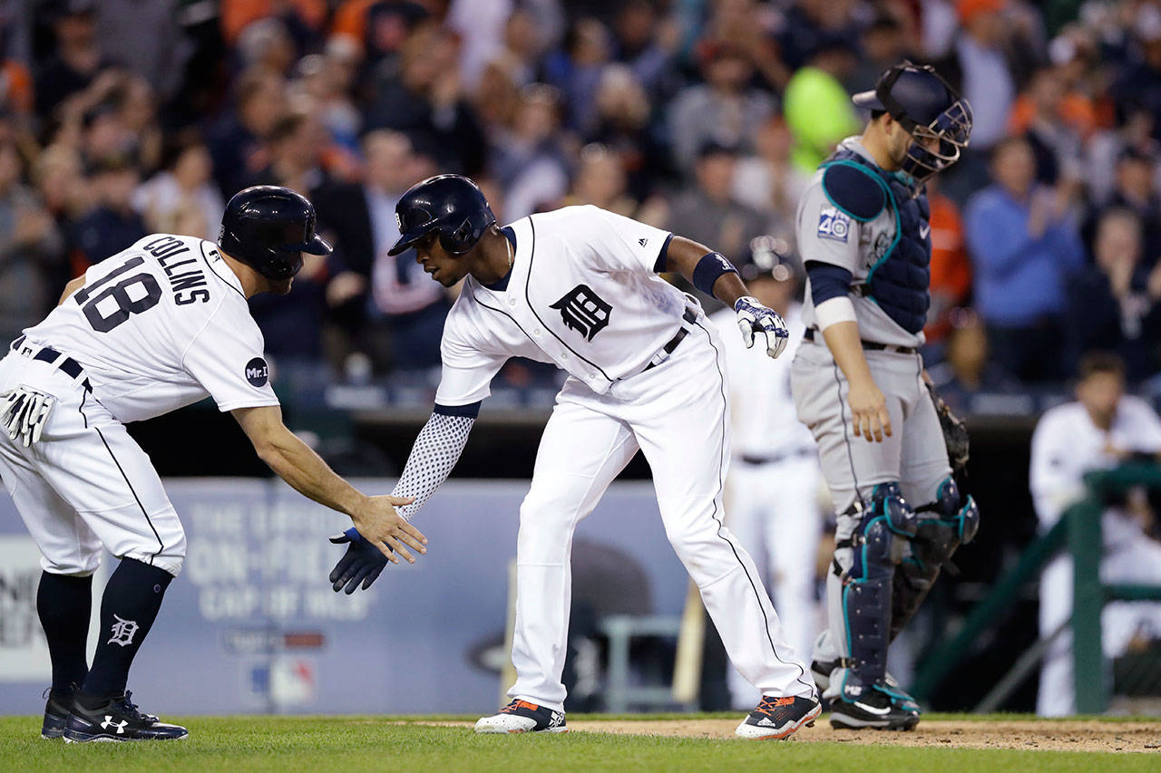 The Tigers&rsquo; Justin Upton (center) is congratulated by Tyler Collins after they scored on Upton&rsquo;s two-run home run in the fourth inning of a game against the Mariners on April 25, 2017, in Detroit. (AP Photo/Carlos Osorio)