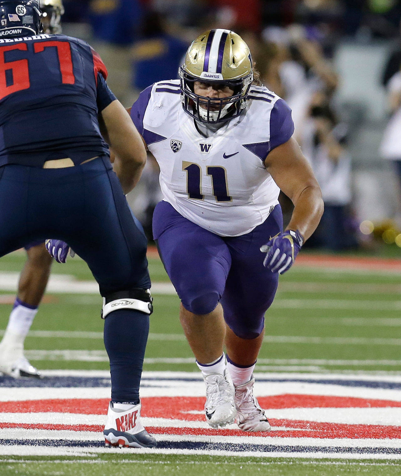 Washington defensive lineman Elijah Qualls (11) during the first half of a game against Arizona on Sept. 24, 2016, in Tucson, Ariz. (AP Photo/Rick Scuteri)