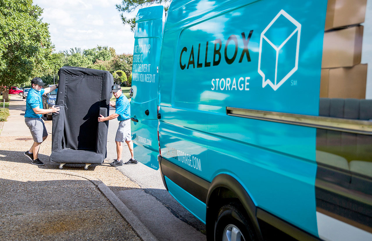 Callbox Storage storage professional Jacob Huttash (left) and Vice President of Operations Luke Collins move a piece of furniture to a moving van Oct. 4 at a client’s home in Dallas. (Ashley Landis/The Dallas Morning News/TNS)