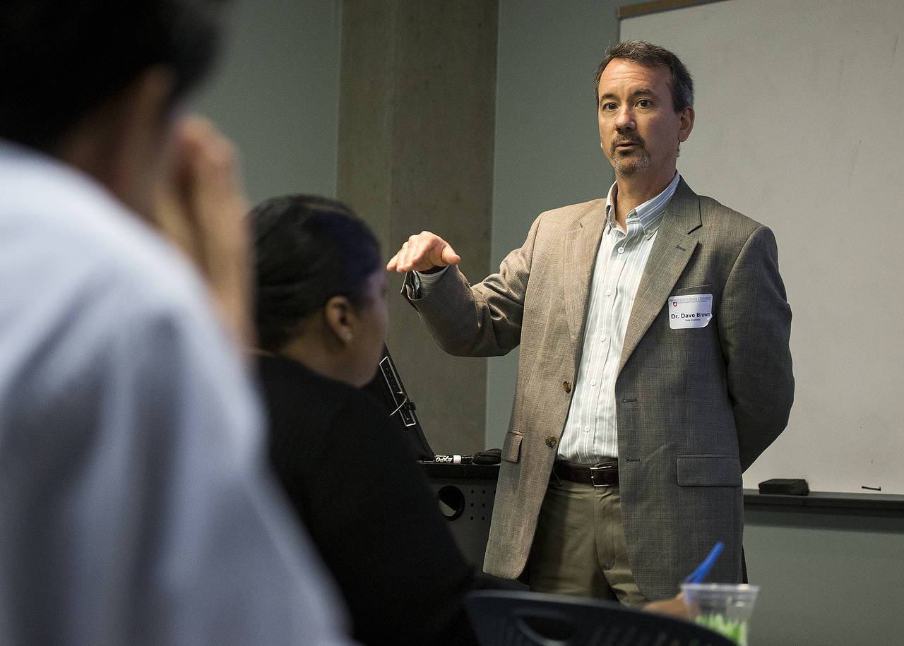 Dave Brown, Washington State University’s program director for Data Analytics, talks with prospective students in Everett last month. Demand for job skills related to data analysis has prompted WSU to start a bachelor’s degree program in the field. (Ian Terry / The Herald)