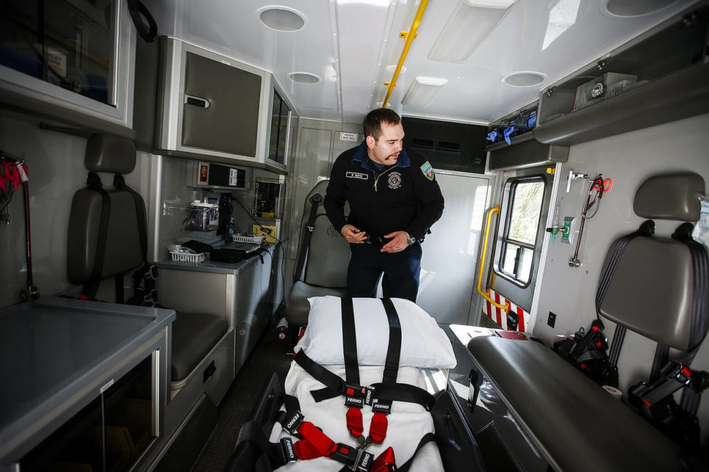 Darrington firefighter Drew Bono walks through the back of a new ambulance purchased with federal grant money on April 25. The new ambulance is the first in Darrington to have bariatric capabilities and four-wheel drive for better handling on the area’s many dirt roads. (Ian Terry / The Herald)
