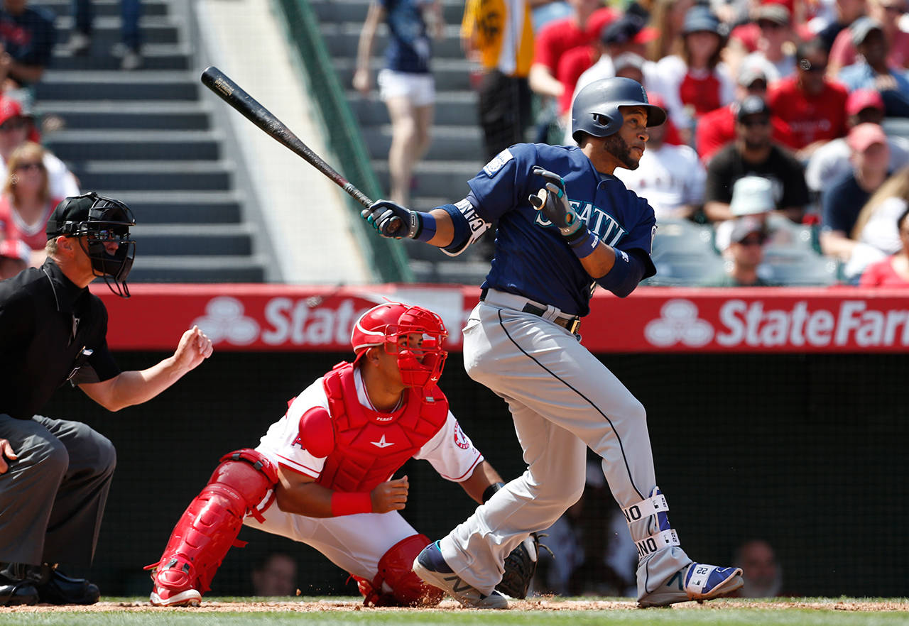 Seattle Mariners’ Robinson Cano hits a two-run double in the fifth inning of a baseball game against the Los Angeles Angels, Sunday, April 9, in Anaheim, Calif. (AP Photo/Christine Cotter)