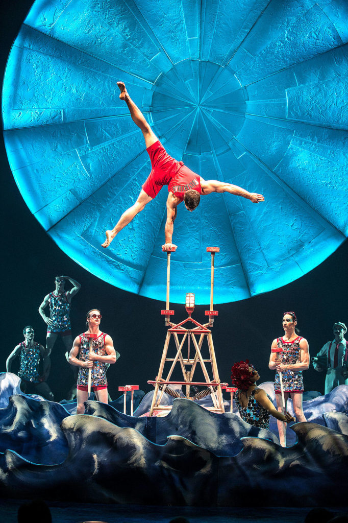 Strongman Ugo Laffolay performs a hand-balancing act while playing a lifeguard on a 1920s movie set in tribute to Mexican cinema in “Luzia.” (Matt Beard photo)
