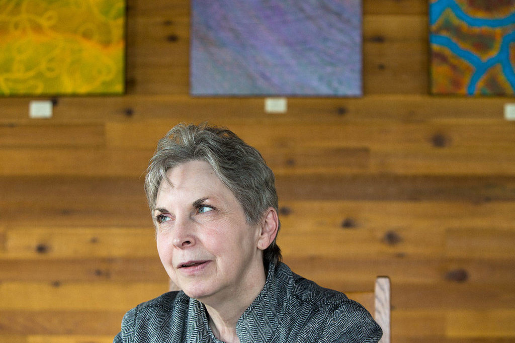 Wyonne Perrault, director of North Counties Family Services, talks about the effects of a mudslide that closed Highway 530 this week. The highway was reopened Wednesday, but residents worry that geologically related closures could become common. (Andy Bronson / The Herald)
