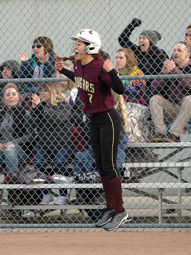 Lakewood freshman pitcher Kassidy Millar leaps after scoring a run against Everett, coached by her father Mike Millar, on Monday in Everett. (Andy Bronson / The Herald)
