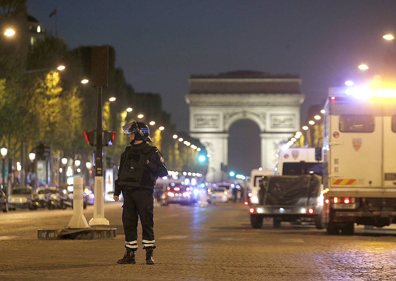 A police officer stands guard after a fatal shooting on the Champs Elysees in Paris, France, on Thursday, April 20. (AP Photo/Thibault Camus)
