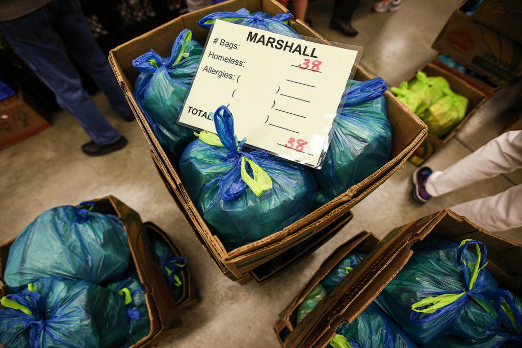 Bags of food at the Marysville Community Food Bank await delivery to schools. (Ian Terry / The Herald)
