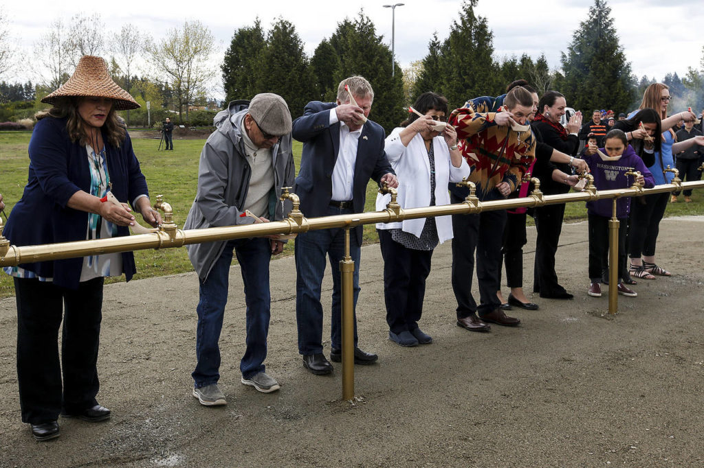 Community leaders take a ceremonial first sip of water. (Ian Terry / The Herald)
