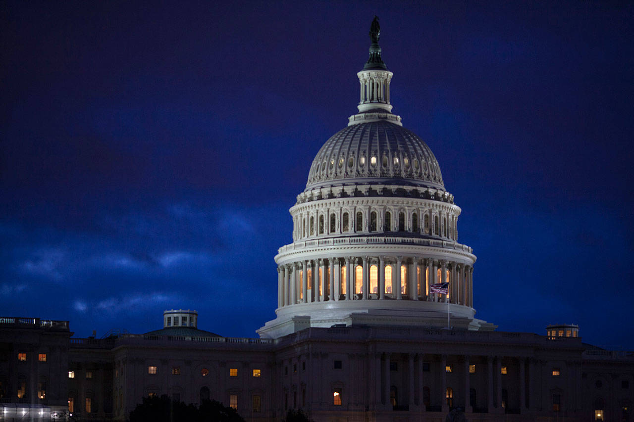 The Capitol is seen at dawn in Washington earlier this month. Top Capitol Hill negotiators reached agreement early Monday morning on a $1 trillion-plus spending bill that would fund the day-to-day operations of virtually every federal agency through Oct. 1. The House and Senate have until Friday at midnight to pass the measure to avert a government shutdown. (Associated Press)