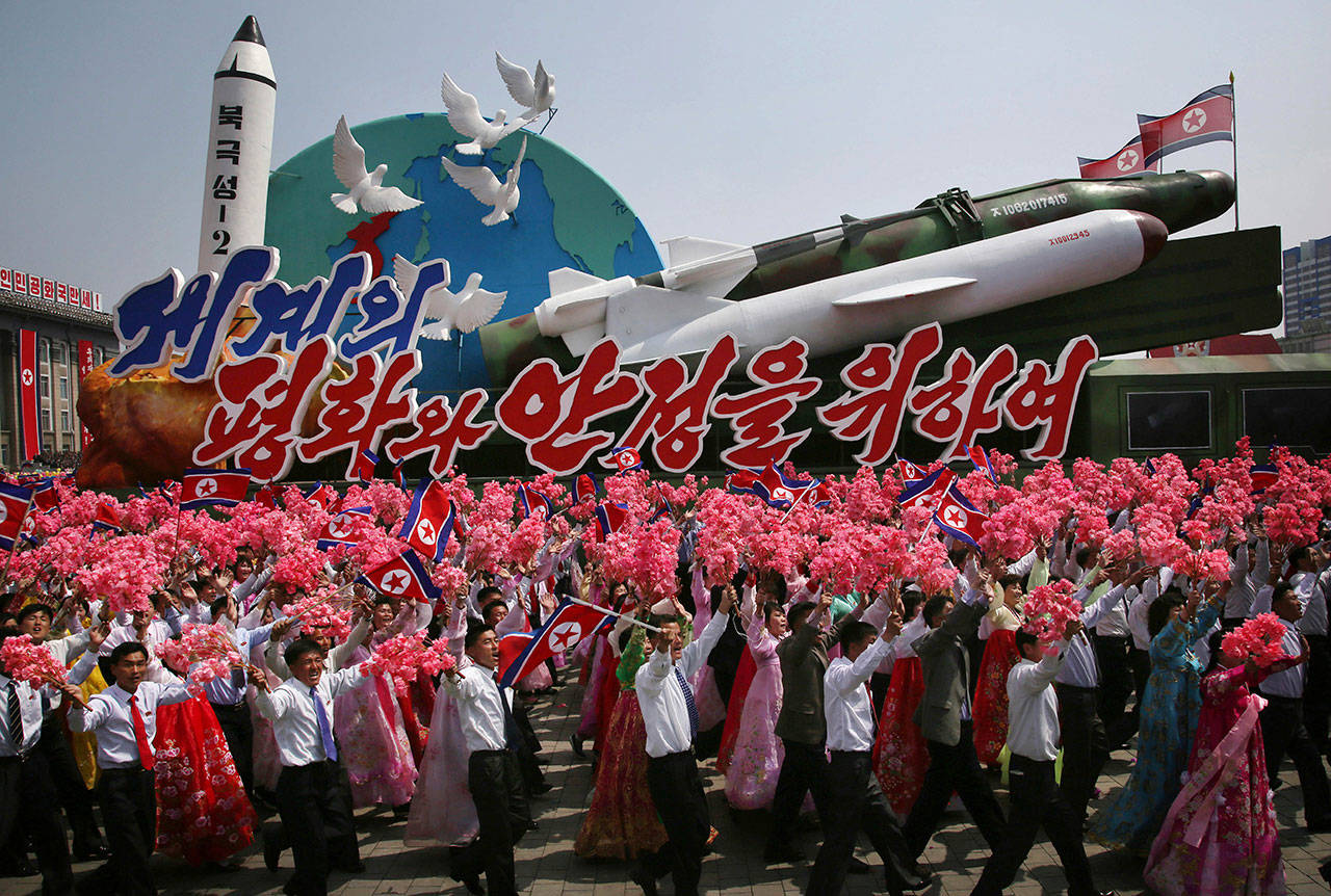 North Koreans wave national flags and artificial flowers as they march next to a float with models of different missiles across Kim Il Sung Square during a military parade to celebrate the 105th birth anniversary of Kim Il Sung in Pyongyang, North Korea on April 15. North Korean tests of nuclear devices and missilies have prompted two Washington state lawmakers to consider updating the state’s emergency preparedness plans to include response to a nuclear attack.