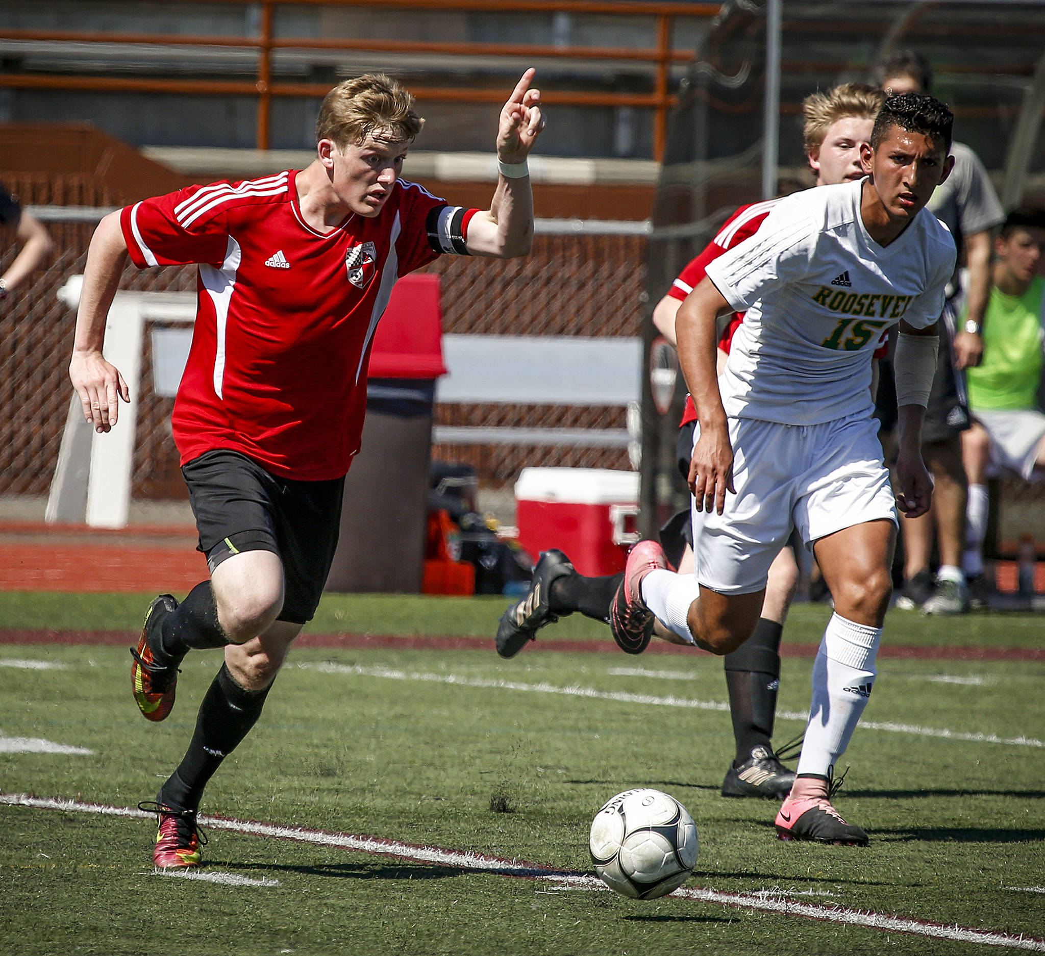 Snohomish’s Jason Fairhurst (left) points before trying to pass to a teammate during the 3A state championship match against Roosevelt on May 27, 2017, at Sparks Stadium in Puyallup. (Ian Terry / The Herald)