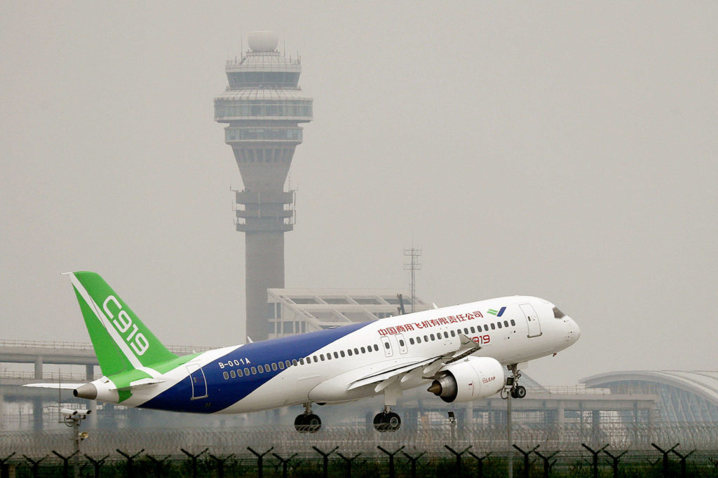 A Chinese-made C919 passenger jet takes off on its first flight at Pudong International Airport in Shanghai on Friday. (AP Photo/Andy Wong, Pool) 
