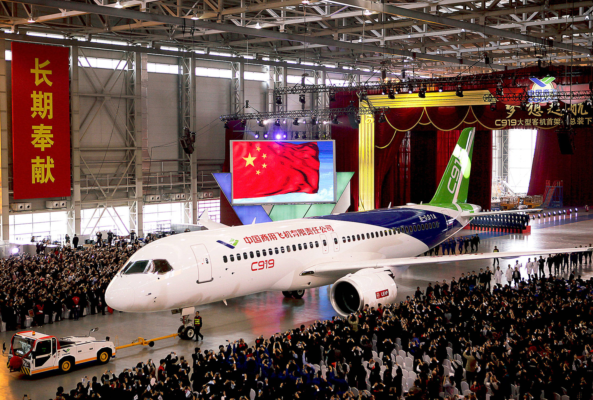 The first twin-engine 158-seat C919 passenger plane made by The Commercial Aircraft Corp. of China is pulled out of the company’s hangar during a ceremony in Shanghai, China, in 2015. (AP Photo)