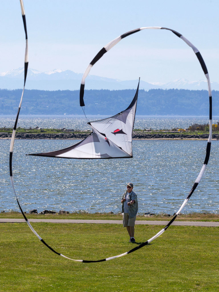 Jim Dygert of Lynnwood flies his dual-line stunt kite at Boxcar Park in Everett on Monday. “You’d have to go to the coast for a better place to fly,” he said. (Andy Bronson / The Herald)

