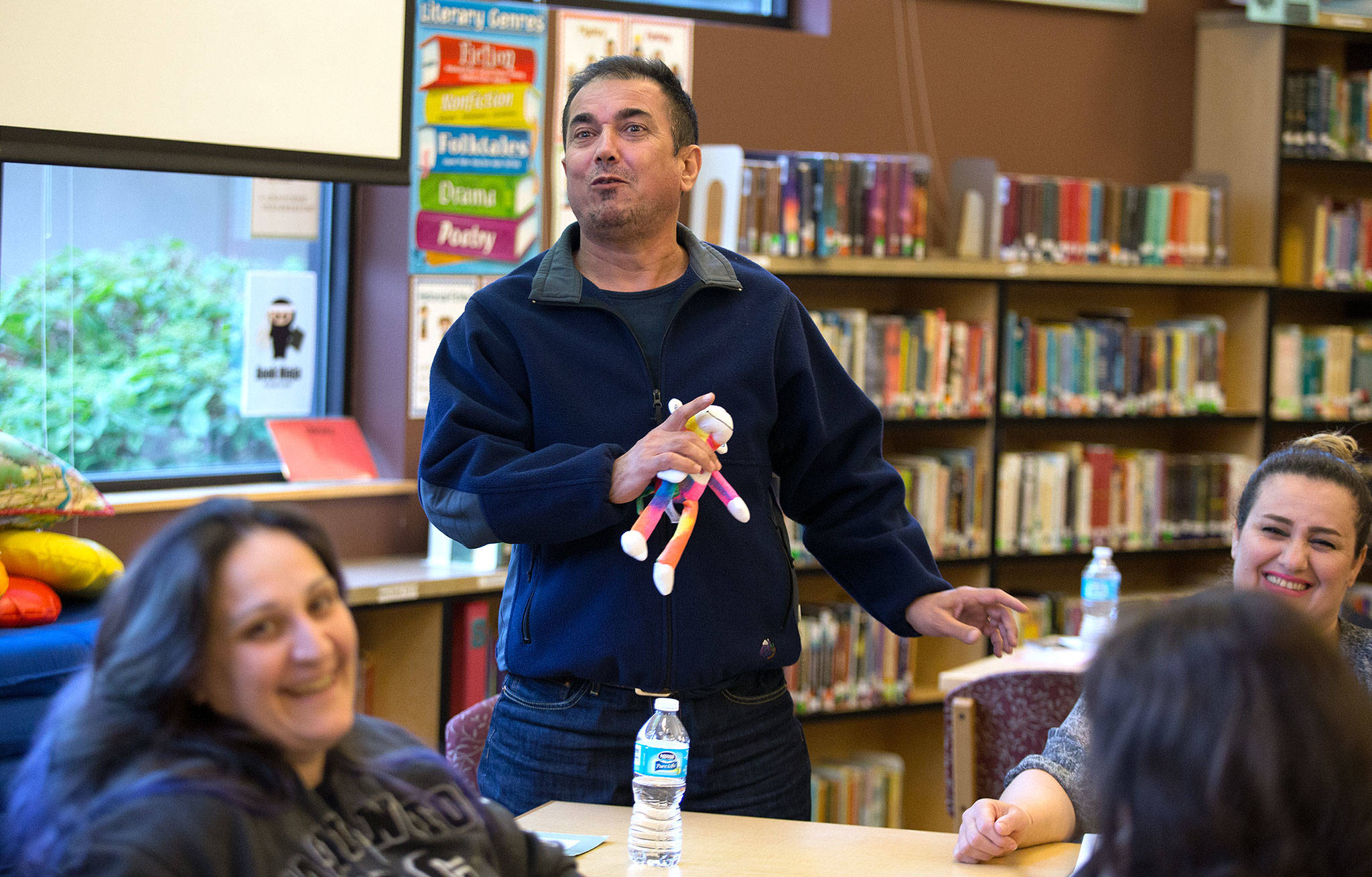 Adnan Kez has the class in stitches as he accidentally says he has three wives when he meant to say three children. He and his wife, Jaymin Shaekhah (right), are learning English at Emerson Elementary School. (Andy Bronson / The Herald)
