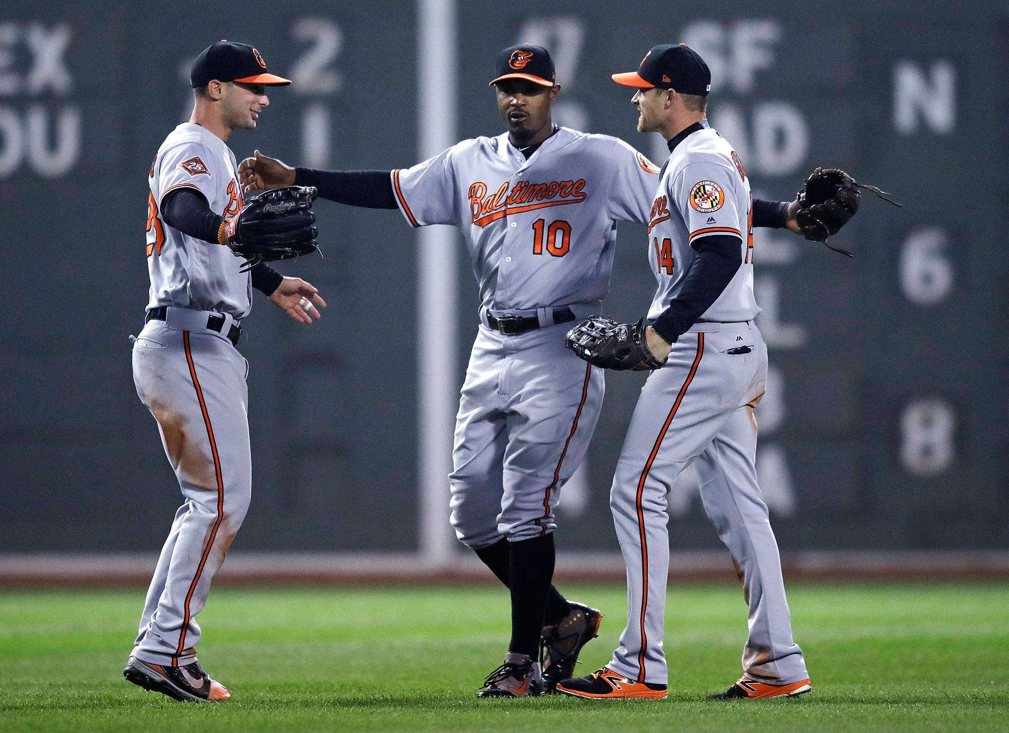 Baltimore center fielder Adam Jones (10) celebrates with right fielder Craig Gentry (right) and left fielder Joey Rickard after the Orioles defeated the Boston Red Sox 5-2 Monday night at Fenway Park in Boston. (AP Photo/Charles Krupa)