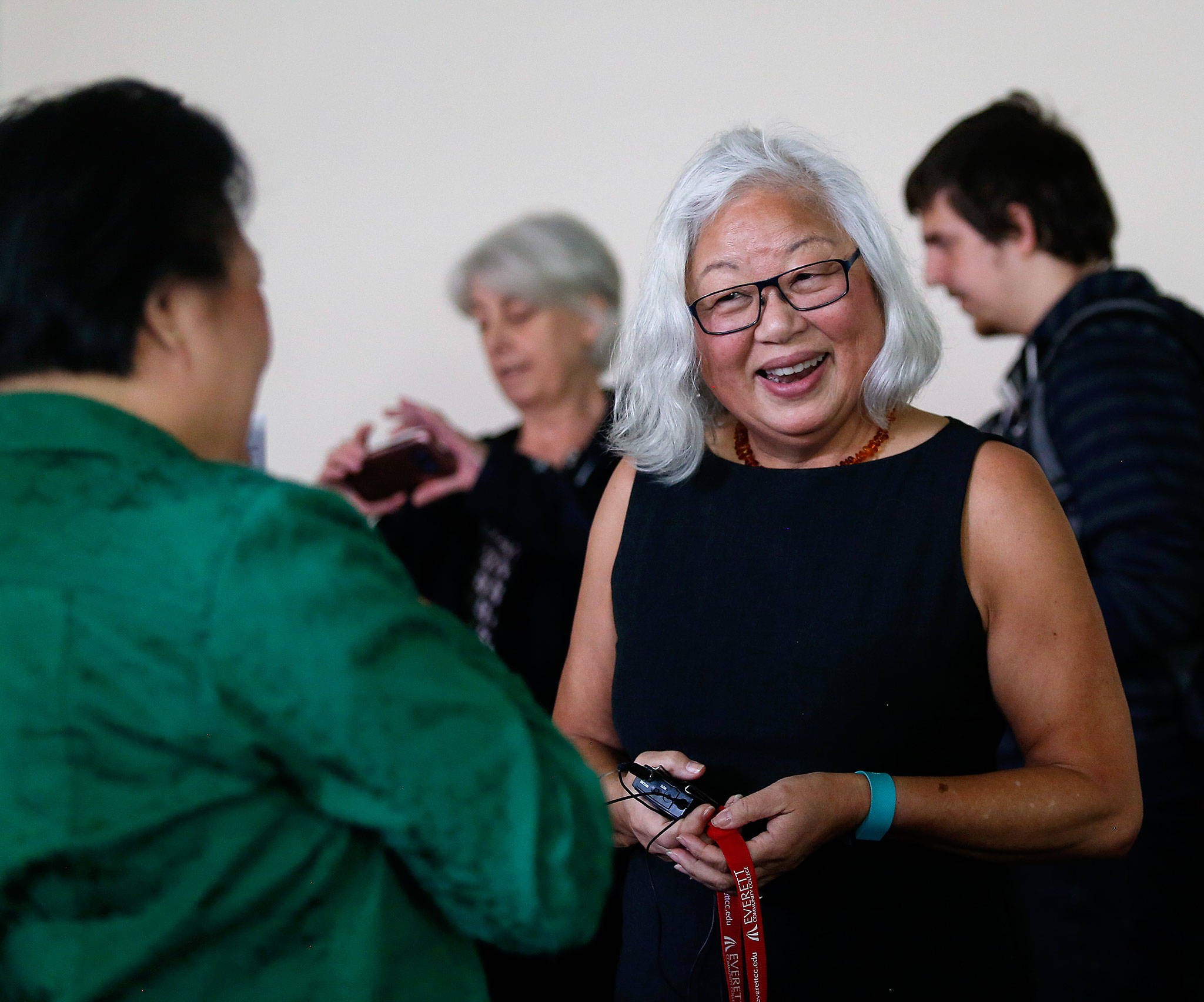 After speaking at Everett Community College about her mother’s wartime experience in Japanese internment camps Tuesday, Mayumi Tsutakawa (facing) is greeted by Van Dinh-Kuno, executive director of Refugee and Immigrant Services Northwest. (Dan Bates / The Herald)