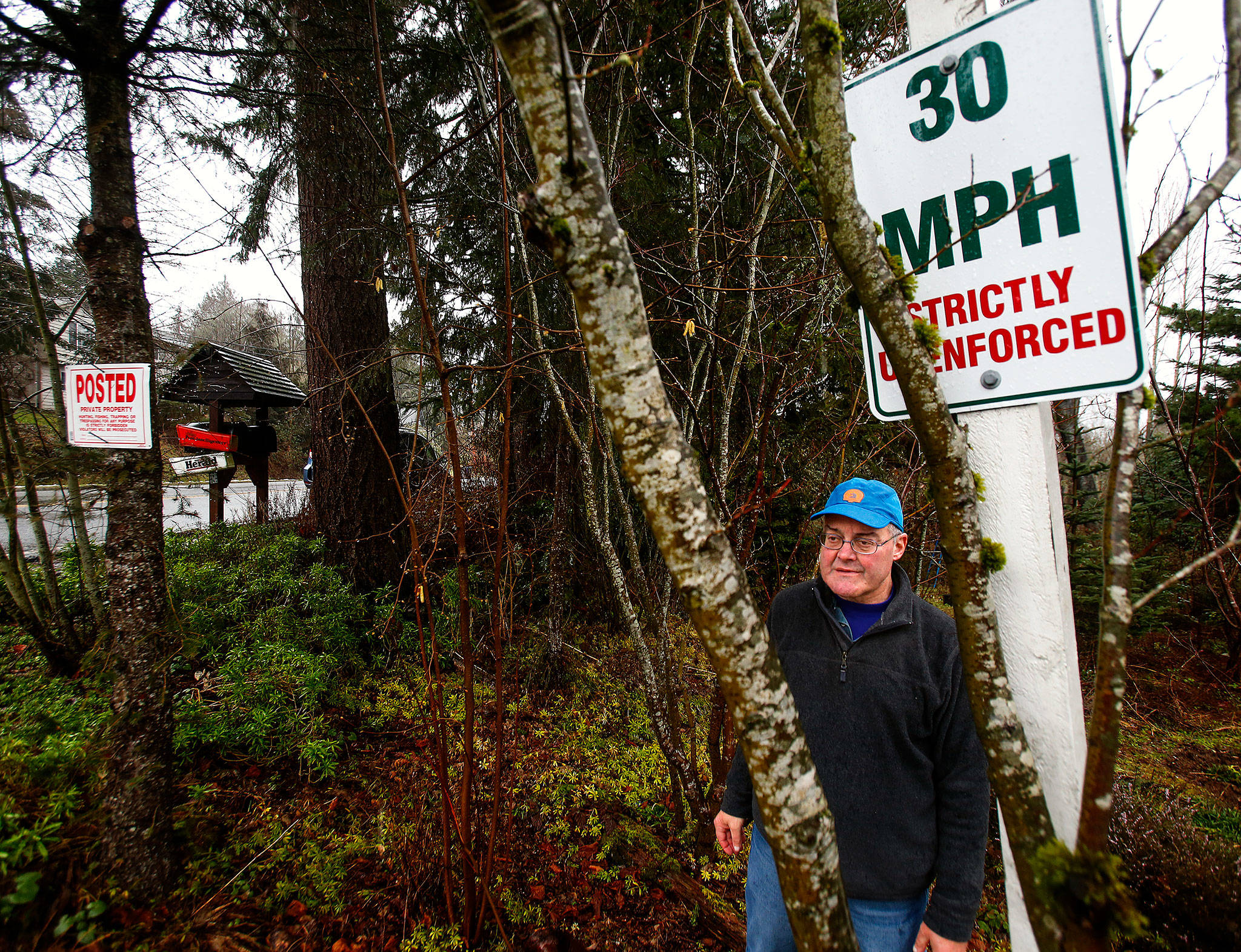 Dick Todd put up a sign trying to slow down traffic along 99th Ave SE in Lake Stevens where it borders his eight acres, but officials took it down. Now he has it wedged between some trees back off the city’s right-of-way. Todd is very concerned about the high density housing going up to accommodate growth in the previously rural area. (Dan Bates / The Herald)