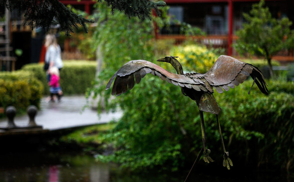 Even on a rainy afternoon such as Thursday, sights and sounds around Bothell’s Country Village are friendly and inviting. (Dan Bates / The Herald)
